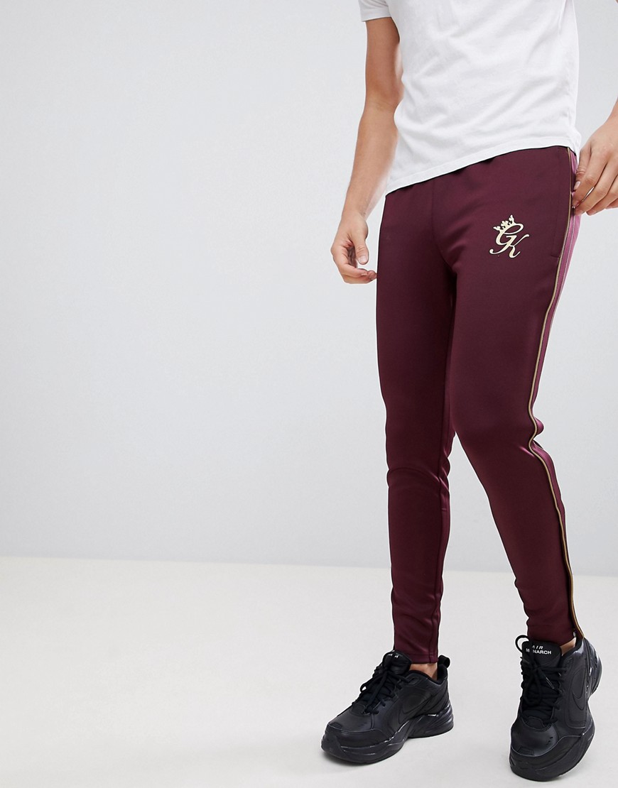 Gym King skinny joggers in burgundy with gold piping