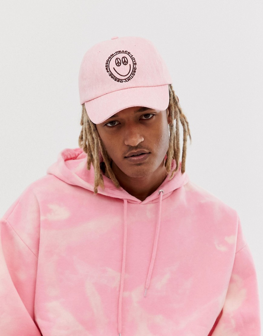 ASOS DESIGN baseball cap in pink washed canvas with peace embroidery
