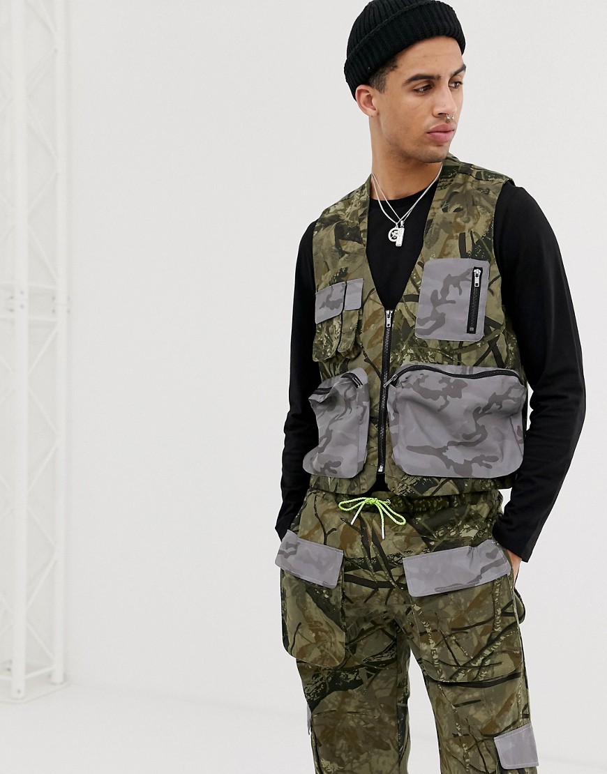 Jaded London Utility vest in camo print with reflective pockets