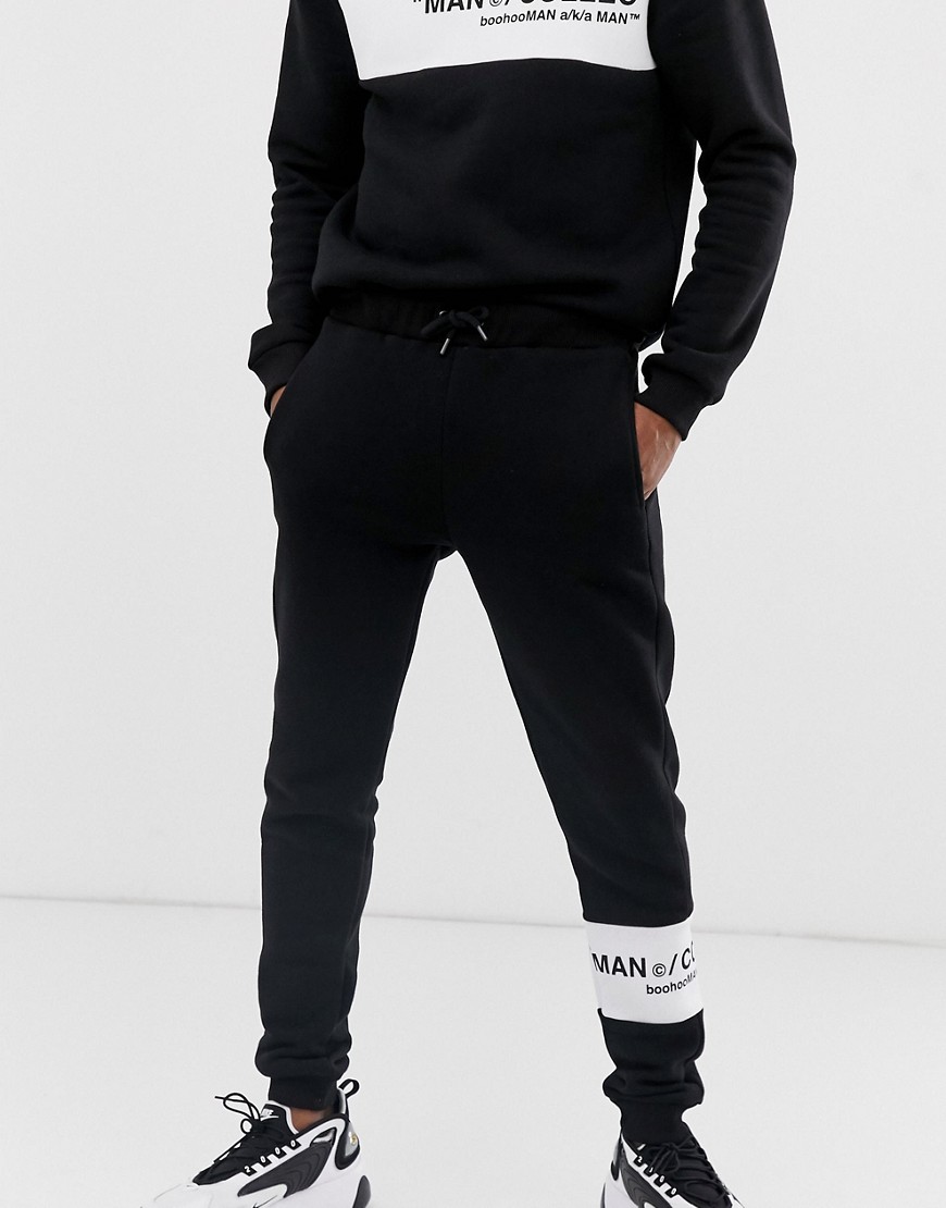 boohooMAN joggers with contrast panel in black
