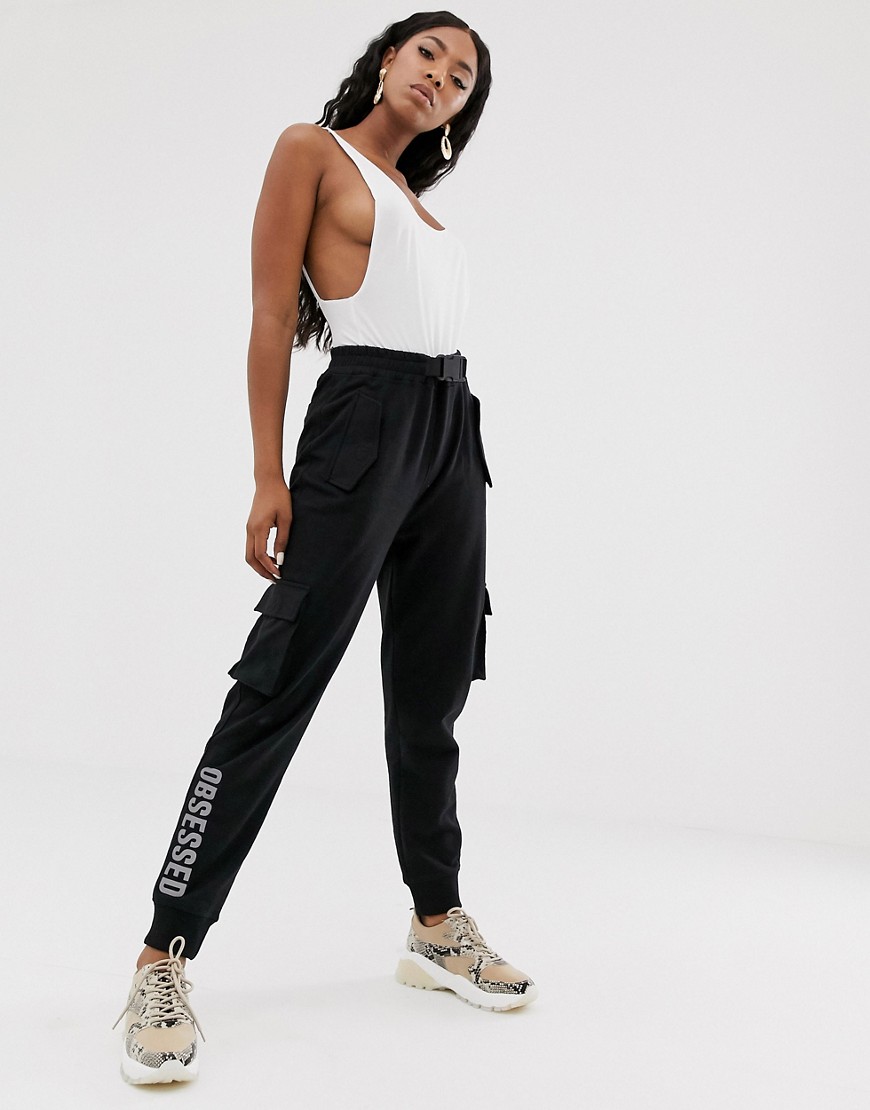Public Desire utility tracksuit bottoms with obsessed leg print