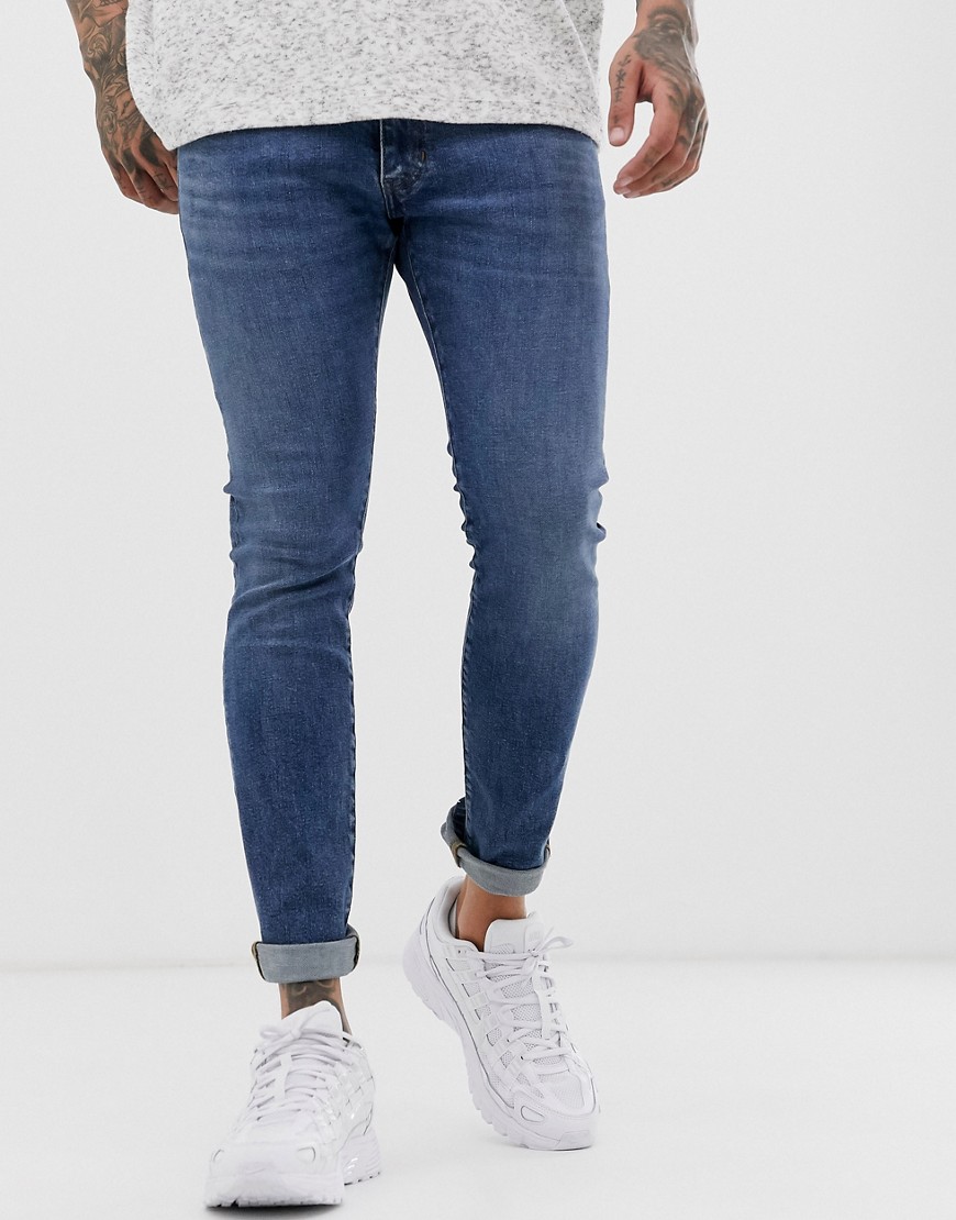 Wrangler bryson skinny jeans in midwash blue