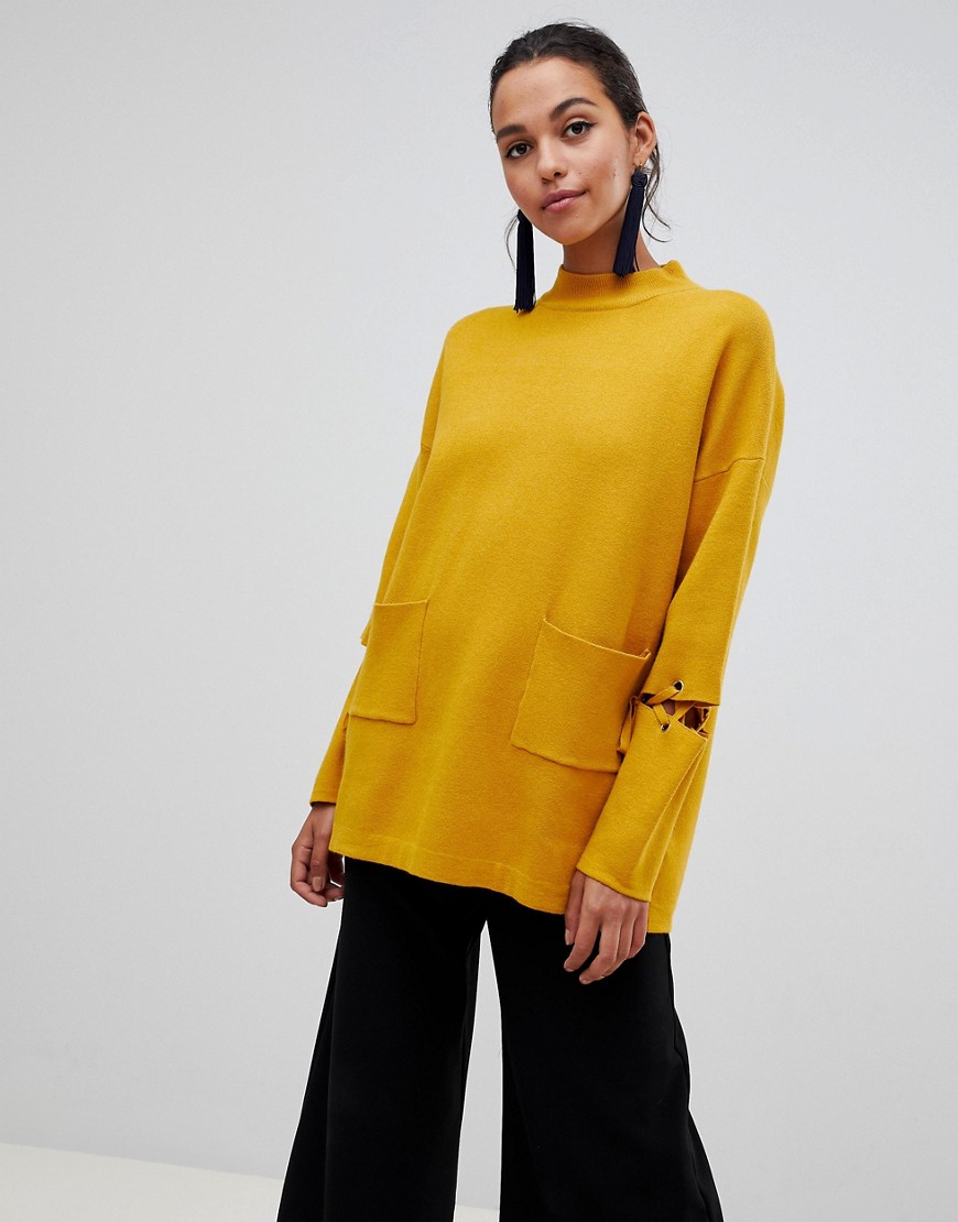 Liquorish long jumper with front pockets and lacing detail on sleeves