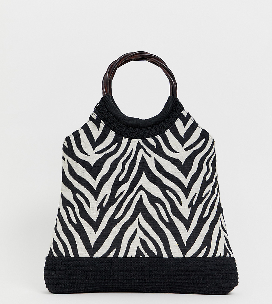 Accessorize zebra print straw bag with interest handle