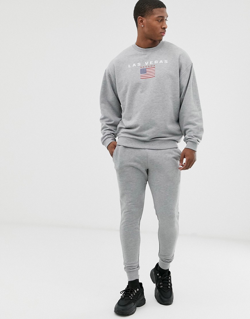 ASOS DESIGN tracksuit in grey marl with city flag chest print