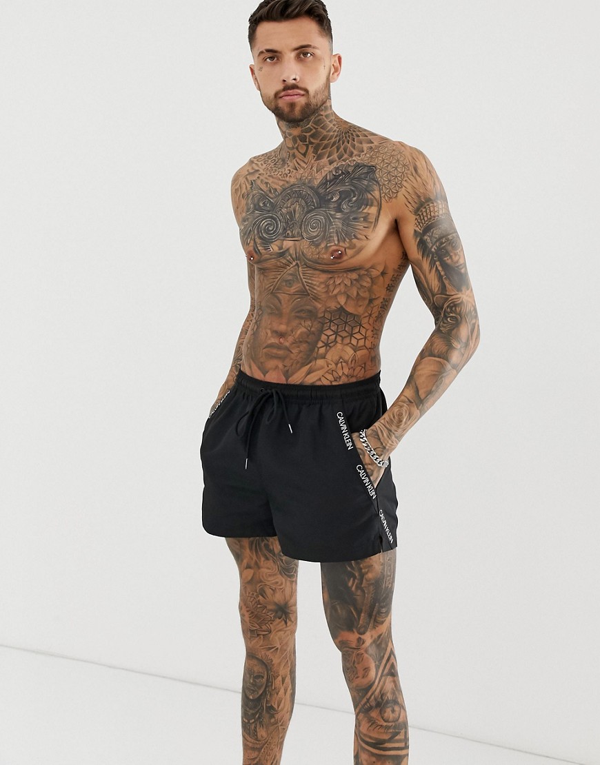 Calvin Klein logo tape swim shorts in black