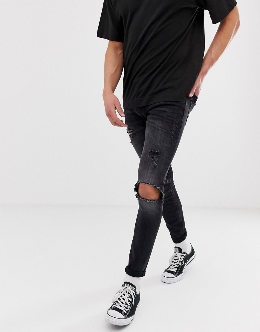 Jack & Jones Intelligence spray on skinny jeans with rip detail in washed black