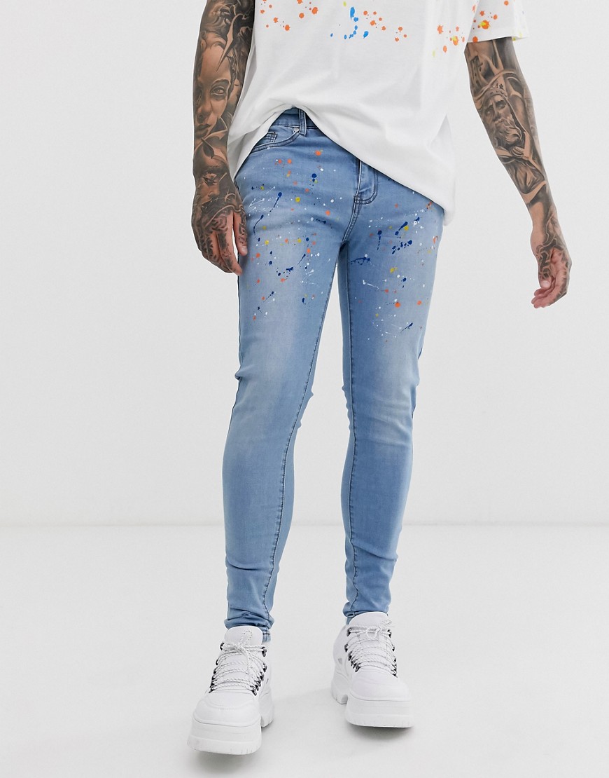 Liquor N Poker skinny jeans with paint splatter in blue wash