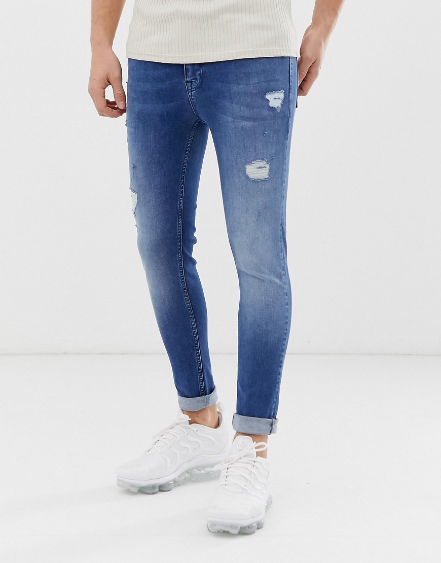 Asos Design Spray On Jeans With Power Stretch In Mid Wash Blue With Abrasions-blues