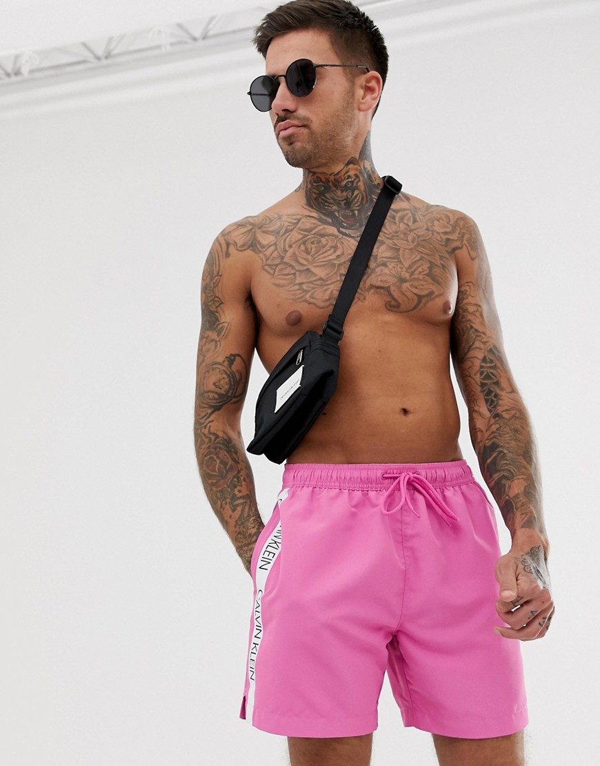 Calvin Klein logo tape swim shorts in pink