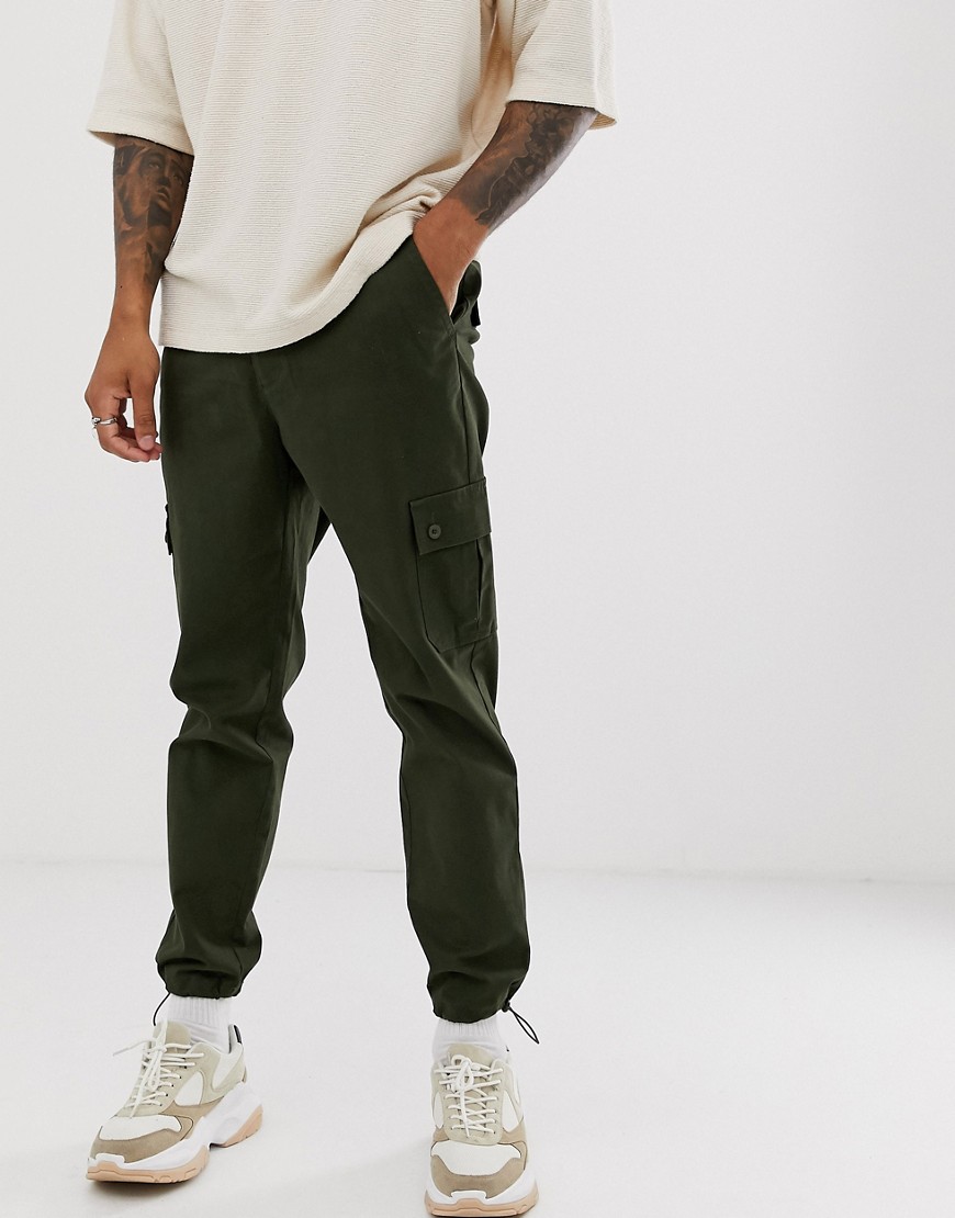 ASOS DESIGN tapered cargo trousers with toggles in green
