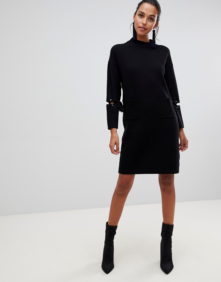 Liquorish long jumper dress with front pockets and lacing detail on sleeves