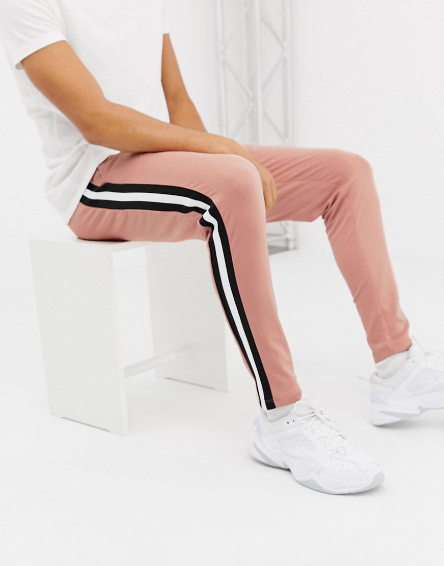 ASOS DESIGN skinny joggers in poly tricot with side stripe in pink