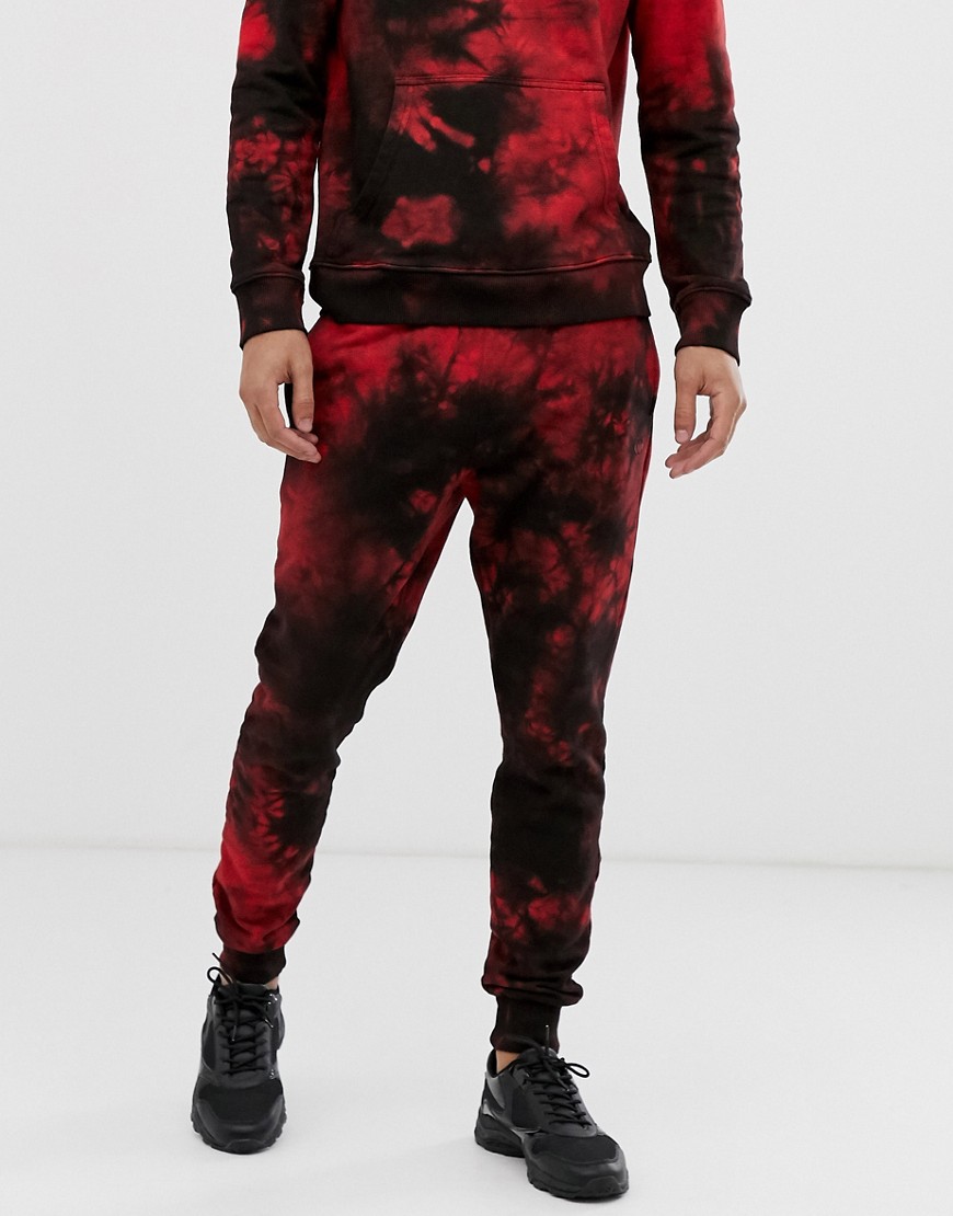 Criminal Damage tie dye joggers in black and red
