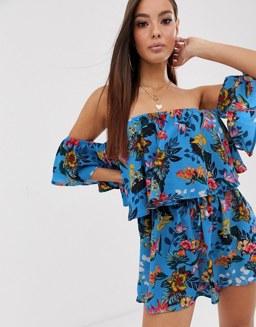 PrettyLittleThing bardot playsuit with frill detail in blue floral