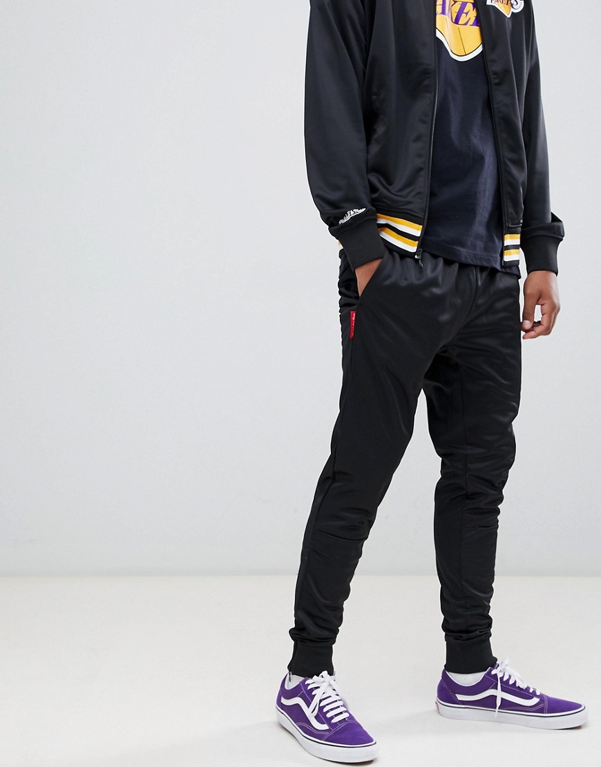 Mitchell & Ness branded track pant in black - Black