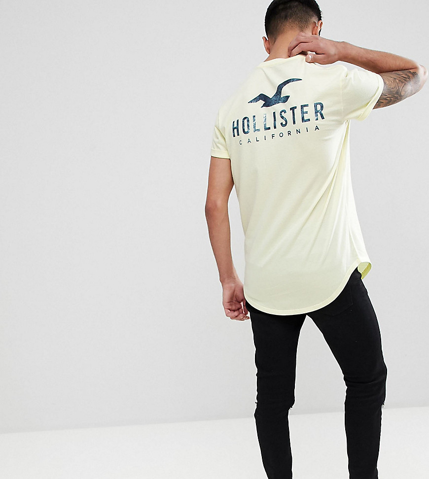 Hollister front and back logo print t-shirt curved hem in yellow Exclusive at ASOS - Yellow