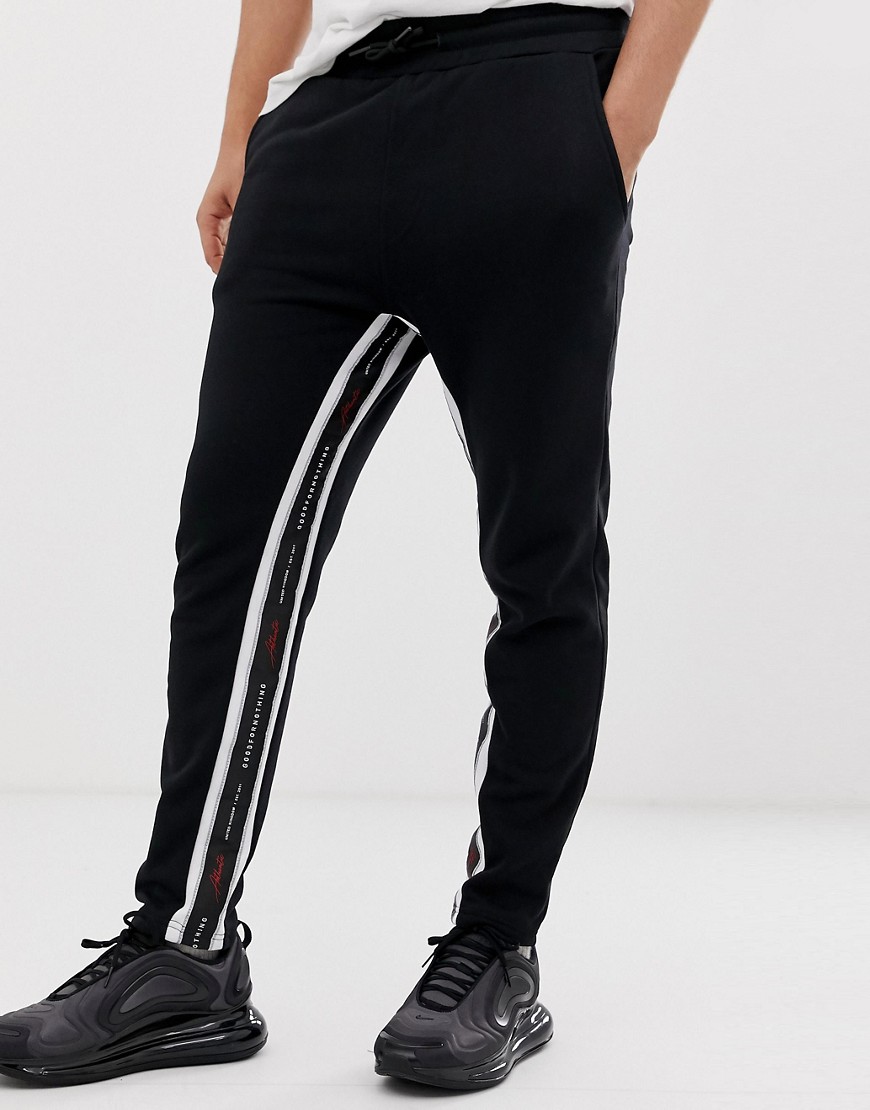 Good For Nothing skinny cropped joggers in black with logo side stripe
