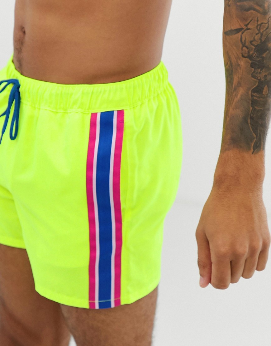 ASOS DESIGN swim shorts in neon yellow with side stripe in short length