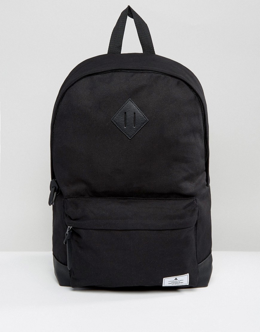 ASOS DESIGN backpack in black canvas with faux leather base and branded patch