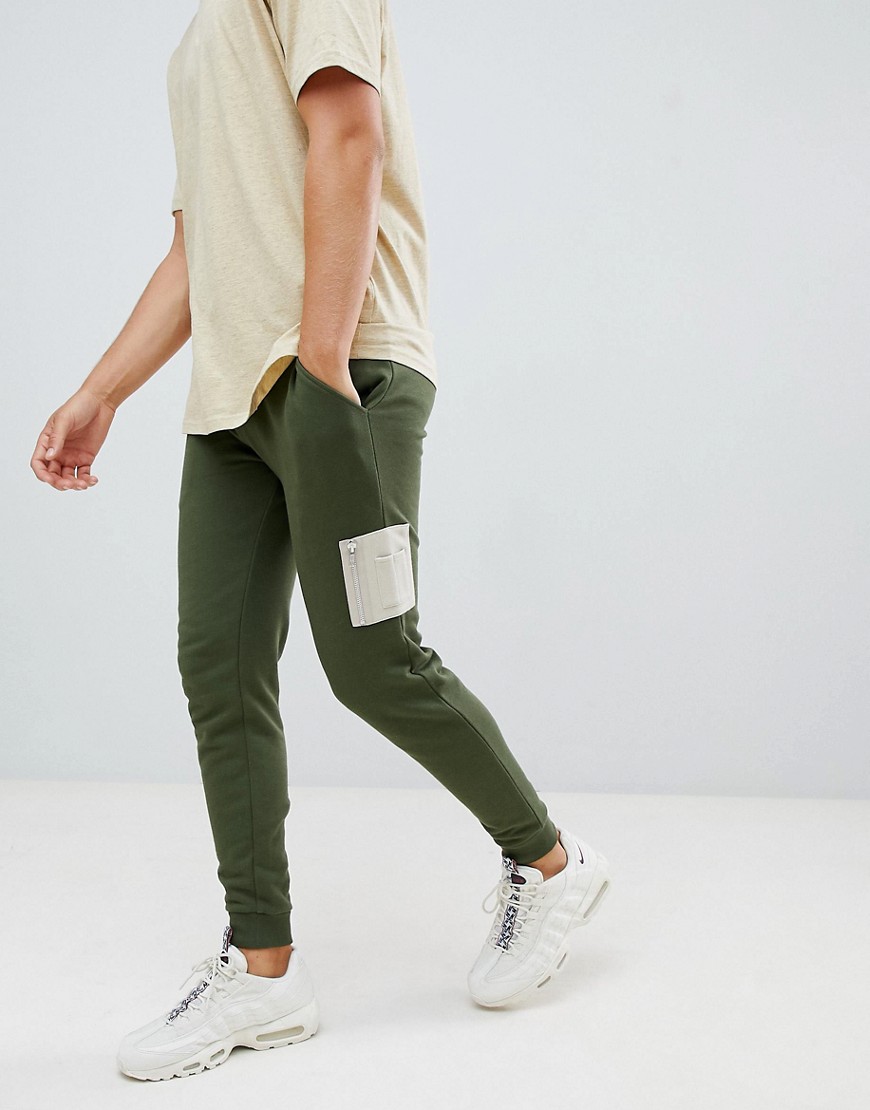 ASOS DESIGN skinny joggers with contrast MA1 pocket in green - Rifle / noodle