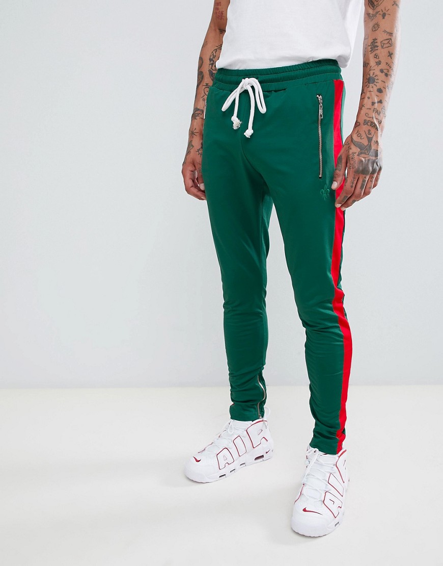 Criminal Damage skinny joggers in green with red side stripe