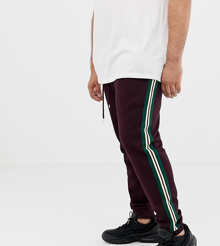 ASOS DESIGN Plus skinny joggers with side stripe taping in burgundy