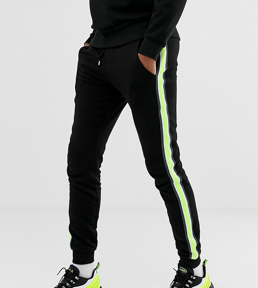 ASOS DESIGN tall skinny joggers with neon side stripe taping in black