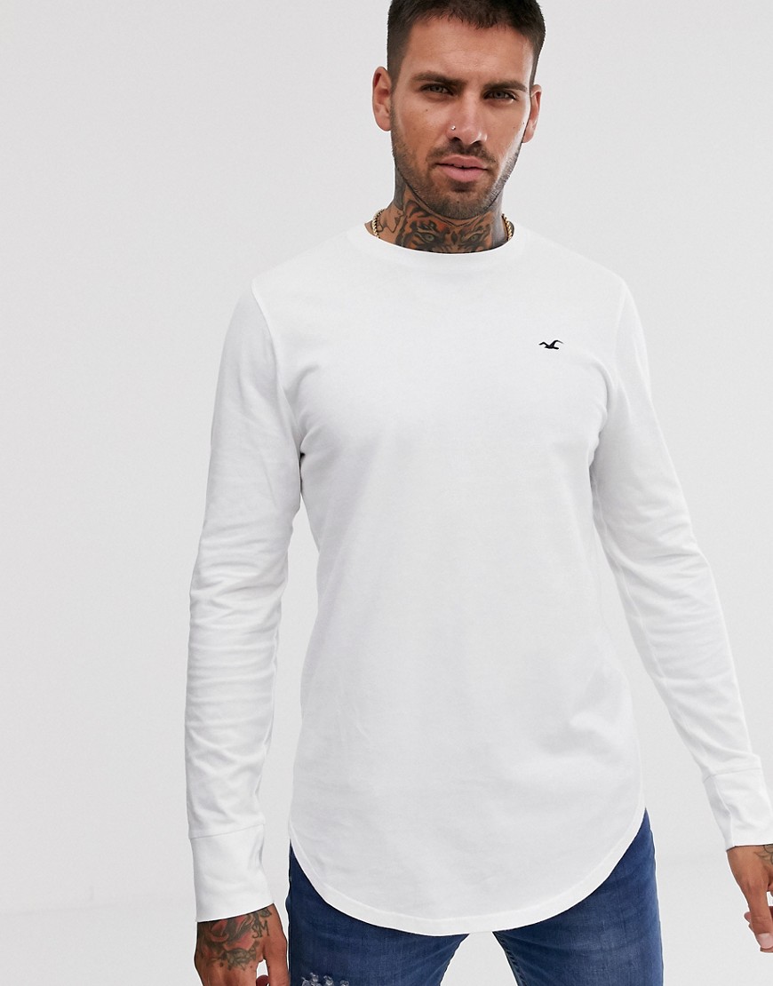 Hollister icon logo curved hem long sleeve top in white