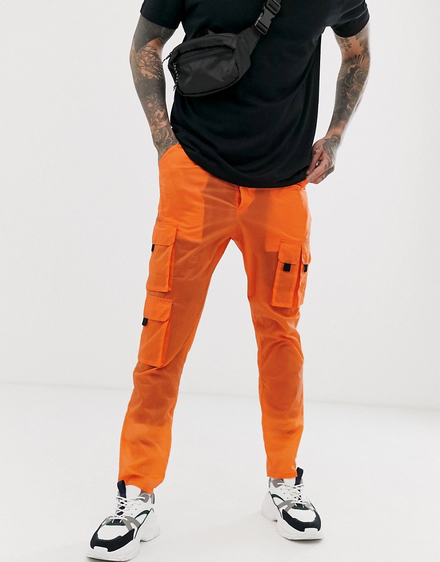 ASOS DESIGN tapered sheer cargo trousers in orange