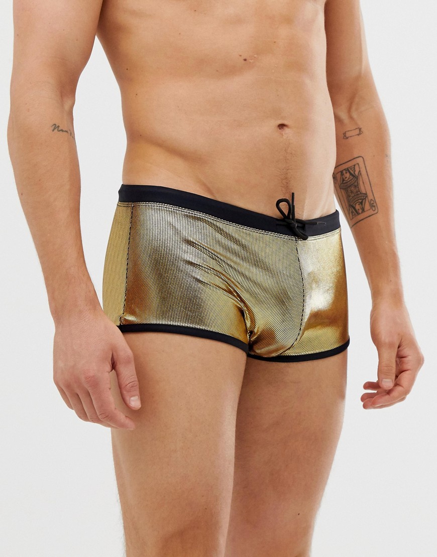 ASOS DESIGN swim trunks in metallic gold