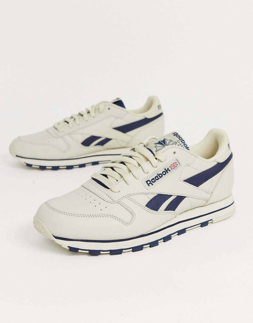 Reebok classic leather trainers in off white with navy vector