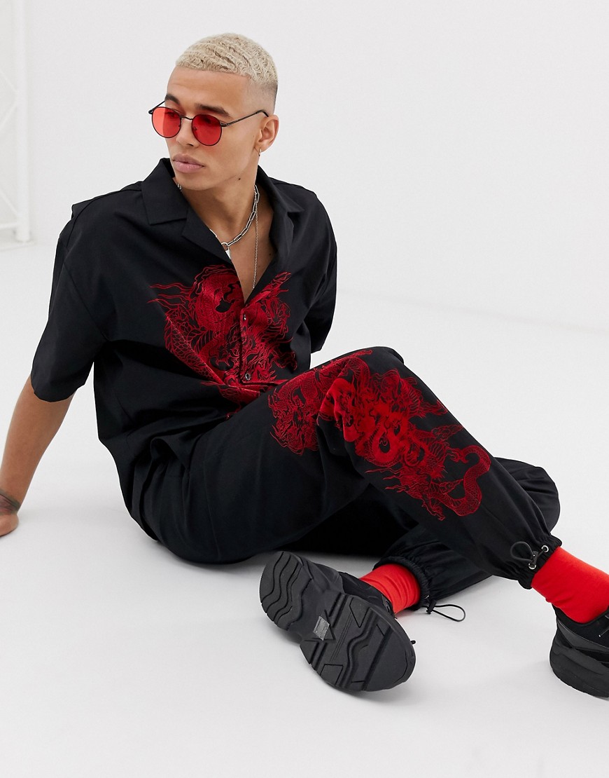 Jaded London co-ord nylon joggers in black with dragon print
