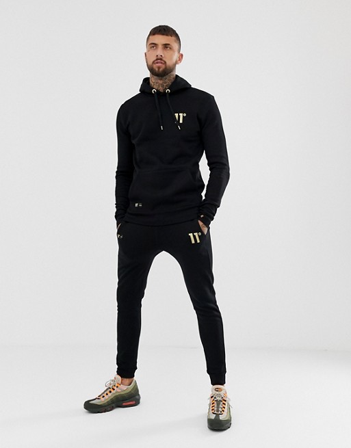 11 Degrees skinny joggers in black with gold logo | ASOS