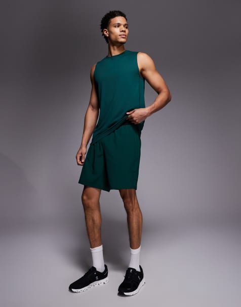 4505 7-inch woven training shorts with elastic waist band and zip pockets in bottle green - view 1