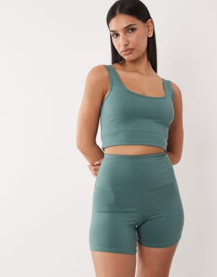 4505 Hourglass Icon Active High Waist 5 Inch Legging Shorts With Zip Phone Pocket In Green