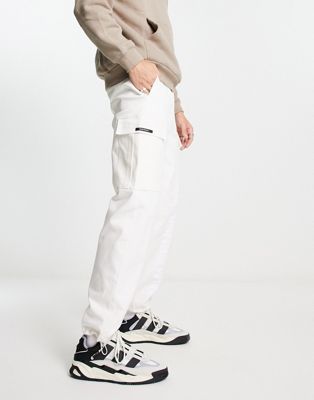 9N1M SENSE cargo trousers in stone with logo print