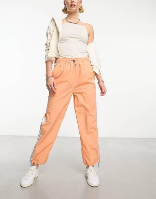 Aape By A Bathing Ape college parachute pants in orange