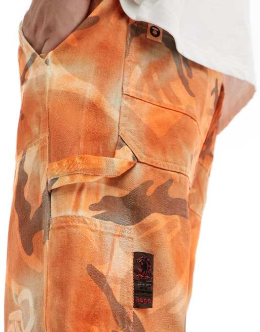 AAPE By A Bathing Ape loose fit camo jeans in orange ASOS