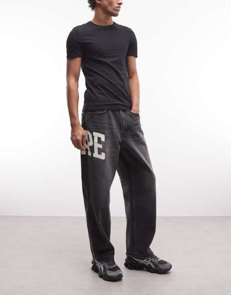 Aape by A Bathing Ape loose fit denim jeans in washed black with logo print - view 1