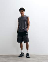 Aape by A Bathing Ape loose fit jersey motocross shorts in black with camo pockets