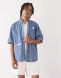 [AAPE BY A BATHING APE®] Aape by A Bathing Ape loose fit striped denim short sleeve shirt in midwash blue Chest 32 Mid wash blue