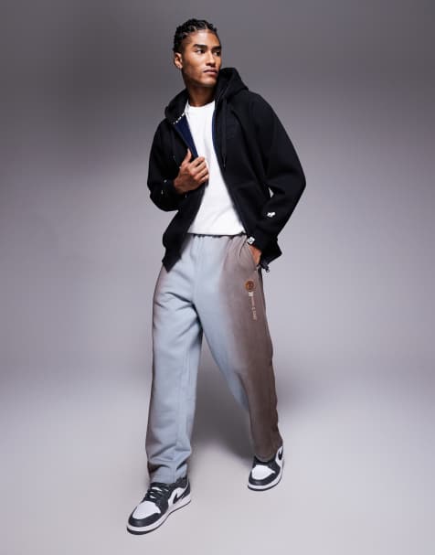 Aape By A Bathing Ape - Losvallende joggingbroek met borduursel op de pijp in blauw met wassing - view 1