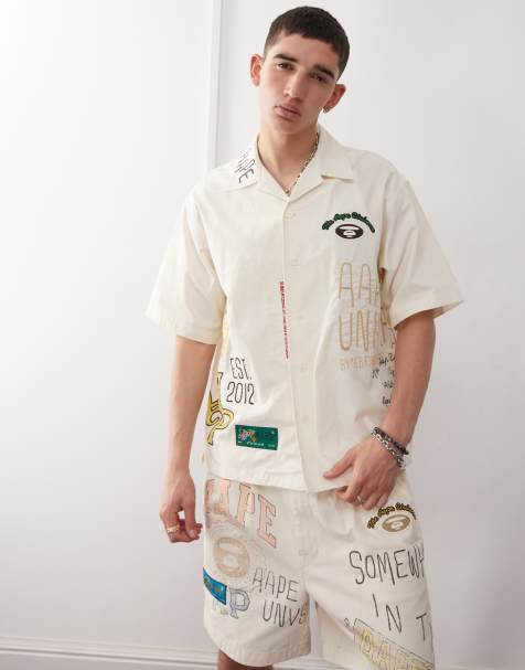Aape by A Bathing Ape multi logo college short sleeve shirt in beige - view 1