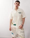 [AAPE BY A BATHING APE®] Aape by A Bathing Ape multi logo college short sleeve shirt in beige-Neutral Chest 32 BEIGE