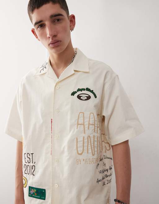 Aape by A Bathing Ape multi logo college short sleeve shirt in beige, 3 of 4