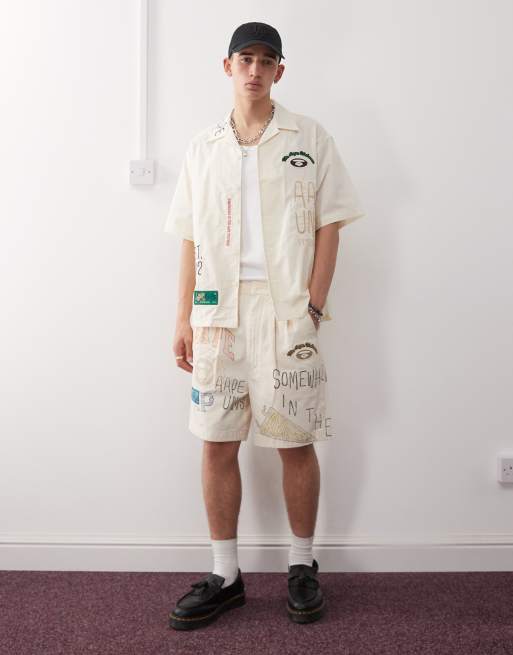 Aape by A Bathing Ape multi logo college short sleeve shirt in beige, 4 of 4