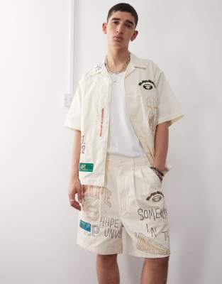 AAPE BY A BATHING APE® Aape by A Bathing Ape multi logo college shorts in beige-Neutral