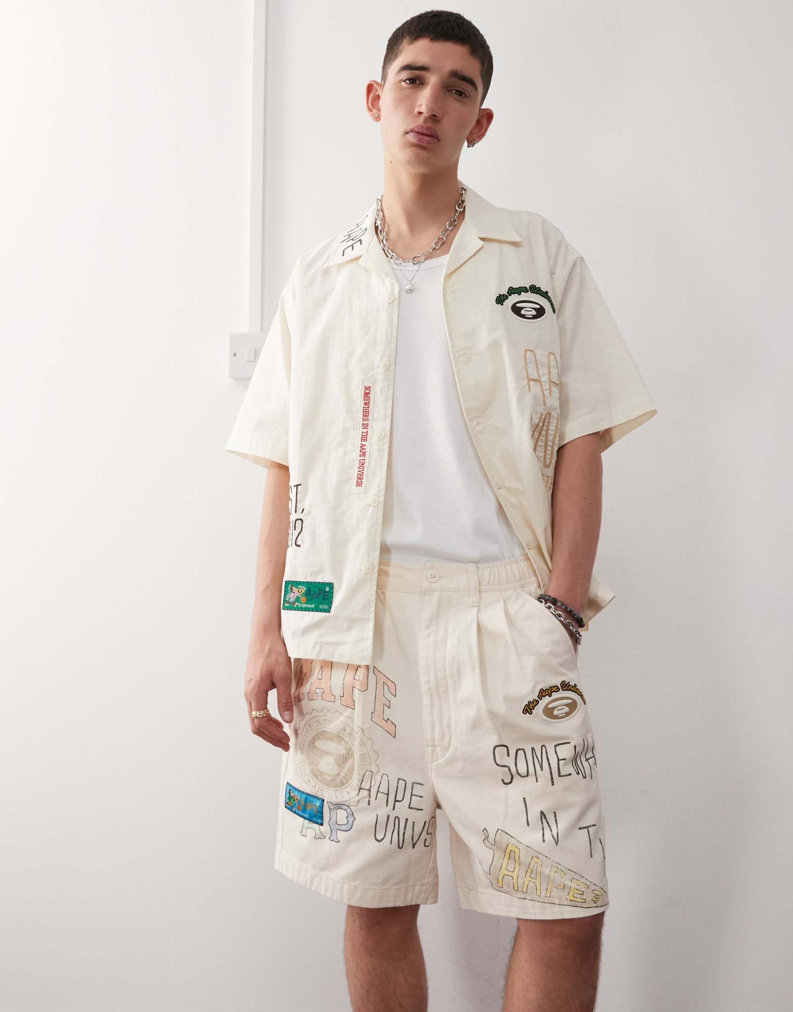 Шорты для колледжа Aape by A Bathing Ape с несколькими логотипами бежевого цвета
