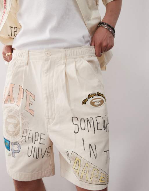 Aape by A Bathing Ape multi logo college shorts in beige